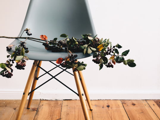 Laetitia Delorme de Monochrome DIY mise sur le coloris océan pour la chaise Eames Plastic Side Chair DSR by Vitra sur son beau plancher et un bouquet de baies, pour le mise en scène finale.