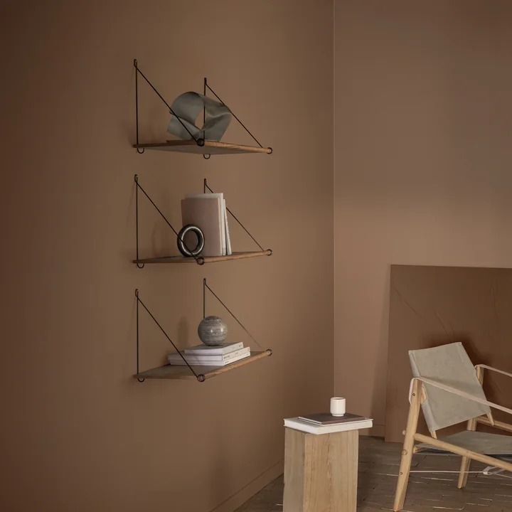 Le site Loop Shelf de We Do Wood dans le salon, sur le mur, comme étagère pour les livres et les éléments décoratifs