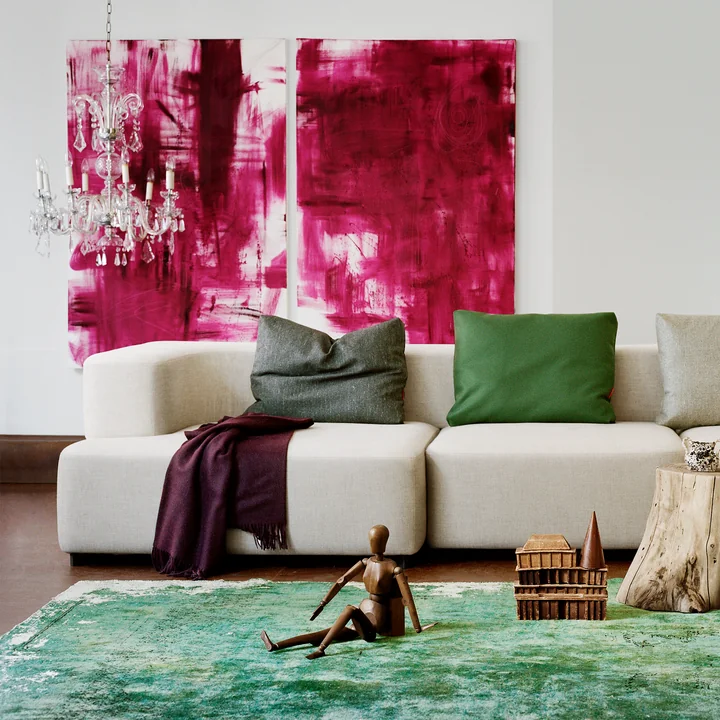 Le canapé modulaire Alphabet Fritz Hansen devant un tapis vert et en combinaison avec des œuvres d'art abstrait