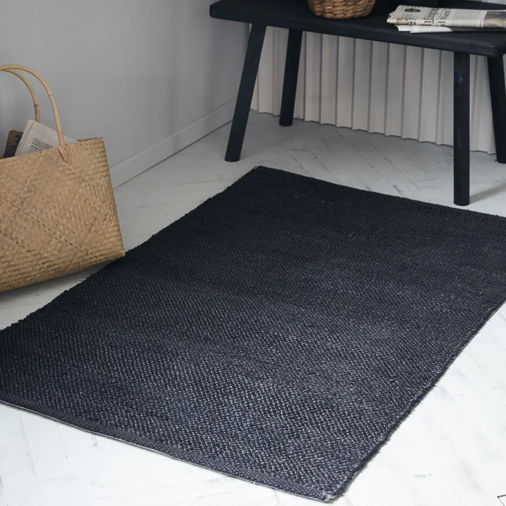 Le tapis noir Hempi de House Doctor devant un banc